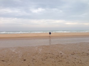 My husband wading into the waters at Omaha Beach